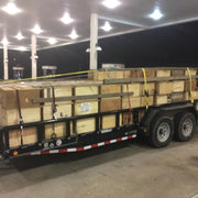 a trailer with crates of bee hives